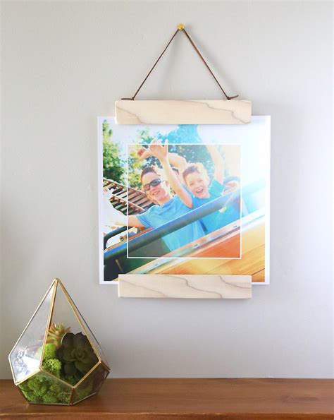 Remove photo and glue the craft stick together in the shape of a frame. Trace photo onto cardboard and cut out. Attach photo to the cardboard with glue stick. When frame has dried paint it and let it dry. Decorate frame with stickers. Turn frame upside down and glue the photo in place.